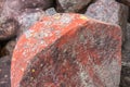Natural  dark red stone crimson quartzite porphyry overgrown with moss and lichen Royalty Free Stock Photo
