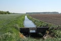 A ditch with a weir in the dutch countryside in springtime