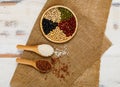 Natural dry organic cereal grains and raw beans beautifully arranged and served on luxury food bowl with wooden spoon of brown