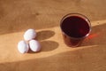 Natural dye easter eggs on wooden table in sunny light. Pastel pink easter eggs painted with beetroot, glass jar with red color Royalty Free Stock Photo