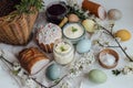 Natural dyed easter eggs, stylish easter bread, ham, beets, butter, cheese on rustic wooden table with spring blossoms. Happy Royalty Free Stock Photo