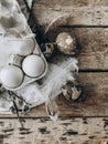 Natural easter eggs, feathers, pussy willow branches, nest on rustic aged wooden table. Flat lay Royalty Free Stock Photo