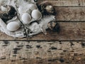 Natural easter eggs, feathers, pussy willow, nest on rustic aged wooden table. Space for text Royalty Free Stock Photo