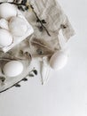 Natural easter eggs, feathers, pussy willow on white rustic table. Flat lay, space for text. Rural