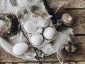Natural easter eggs, feathers, willow branches, nest on rustic aged wooden table. Rural still life Royalty Free Stock Photo