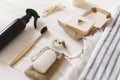 natural eco bamboo toothbrush, coconut soap, handmade detergent, crystal deodorant, bamboo ear sticks on towel, bathroom