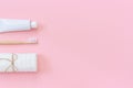 Natural eco-friendly bamboo brush, white towel and tube of toothpaste. Set for washing and brushing your teeth on pink background Royalty Free Stock Photo