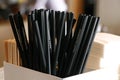 Natural eco-friendly disposable paper straws in coffee shop on wooden background with copy space. Save the earth, waste reduction