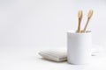 Natural eco friendly toothbrush with wooden bamboo handle in a white cup