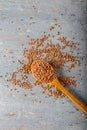 Natural Einkorn bulgur in wooden spoon on wooden background. Top view.