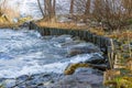 Natural engineering - soil bioengineering. Shore protection from water erosion with wooden trunks