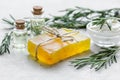 Natural essential aroma oil with rosemary on stone table background Royalty Free Stock Photo