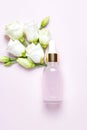 Natural essential oil, serum in a glass drop bottle on a pink background. Alternative medicine, aromatic herbal beauty