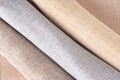 Natural fabrics from organic colors of flax and cotton in rolls, homespun textile handmade. Heap of cloth fabric Royalty Free Stock Photo