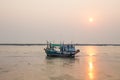 Natural fishing boat on the lane at low tide, background beautiful