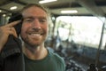 Natural fitness lifestyle portrait of young happy and attractive man training wiping the sweat with towel at gym smiling cheerful Royalty Free Stock Photo