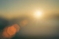 Natural fog and mountains sunlight background blurring, misty waves warm colors and bright sun light. Christmas background sky Royalty Free Stock Photo