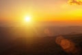 Natural fog and mountains sunlight background blurring, misty waves warm colors and bright sun light. Christmas background sky