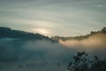 Natural fog and mountains sunlight background blurring, misty waves warm colors and bright sun light. Background sky sunny color Royalty Free Stock Photo