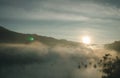 Natural fog and mountains sunlight background blurring, misty waves warm colors and bright sun light. Background sky sunny color Royalty Free Stock Photo