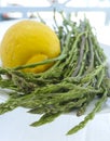 Natural food from forest and mountains in Greece green wild asparagus and lemon on balcony with sea view Royalty Free Stock Photo