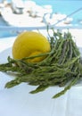 Natural food from forest and mountains in Greece green wild asparagus and lemon on balcony with sea view Royalty Free Stock Photo