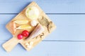 Natural food ingredients for healthy dish on cutting board. Top view on wooden table with copy space Royalty Free Stock Photo