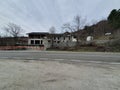 natural, forest and mountainous landscape showing a road and an abandonned building