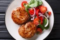 Natural French fried meat balls crepinette and fresh vegetable salad close-up on a plate. horizontal top view Royalty Free Stock Photo