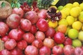 Natural fresh fruits yellow lemons, oranges and red pomegranates