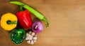 Natural fresh organic Bell pepper red green yellow, hot peppers, shallot and garlic on Cutting Board isolated on white background Royalty Free Stock Photo