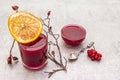 Natural fresh organic smoothies and jam made of viburnum, wild rose and grapefruit. In a glass on a stone background. Dog rose