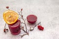 Natural fresh organic smoothies and jam made of viburnum, wild rose and grapefruit. In a glass on a stone background. Dog rose