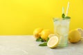 Natural freshly made lemonade on grey marble table, space for text. Summer refreshing drink