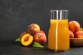 Natural freshly made peach juice on grey table