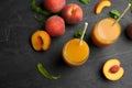 Natural freshly made peach juice on grey table, flat lay