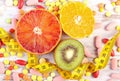 Natural fruits, centimeter and medical pills, slimming, choice between healthy nutrition and medical supplements Royalty Free Stock Photo