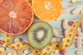 Natural fruits, tape measure and medical pills. Choice between healthy nutrition and supplements Royalty Free Stock Photo