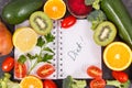 Natural fruits with vegetables as source vitamins and notepad with word diet, healthy nutrition concept