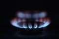 Natural gas burning a blue flames on black background Royalty Free Stock Photo