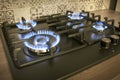 Natural gas burning by blue flames in kitchen stove. Food cooking concept. Royalty Free Stock Photo