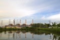 Natural gas electric power plant with smokestack and many pole in chonburi thailand with water reflection and beautiful sky near Royalty Free Stock Photo