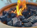 Natural gas fire pit with ceramic rocks and flames Royalty Free Stock Photo