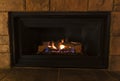Natural gas fireplace with ceramic log keeping home warm Royalty Free Stock Photo
