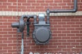 Natural gas meter gauge and pipeline on the red brick wall Royalty Free Stock Photo