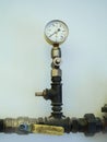 Natural gas pipe and valve in the apartment with pressure clock Royalty Free Stock Photo