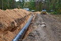 Natural gas pipeline construction work. A dug trench in the ground for the installation and installation of industrial gas and oil Royalty Free Stock Photo