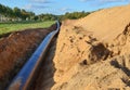 Natural gas pipeline construction work. A dug trench in the ground for the installation and installation of industrial gas and oil Royalty Free Stock Photo