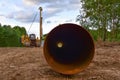 Natural gas pipeline construction work in forest area. Installation of  gas and crude oil pipes in ground. Pipe on top of wooden Royalty Free Stock Photo