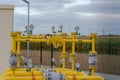 Natural gas pumping station with yellow pipes under a cloudy sky. Royalty Free Stock Photo